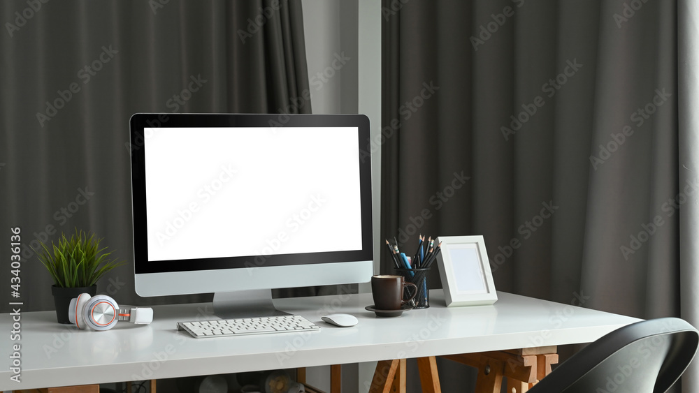 Home office desk with mock up computer with blank white screen. Home office desk with mock up computer with blank white screen.