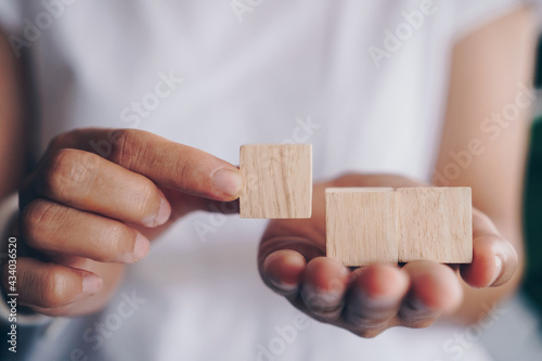 Blank wooden cube that you can put text or icon on in hand hold