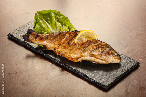 Grilled trout served lemon slice