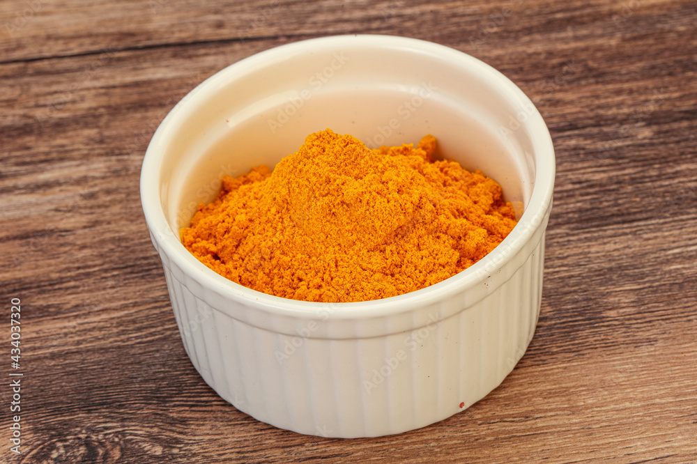 Tumeric powder in the bowl Tumeric powder in the bowl