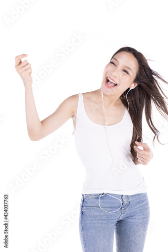 Portrait of young happy asian woman listening favorite music isolate on white background.