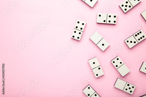Domino pieces on the pink background with copy space
