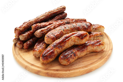 Roasted sausage on cutting board isolated on white background