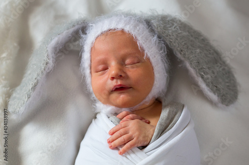 Portrait of a newborn sleeping boy in a hat with ears