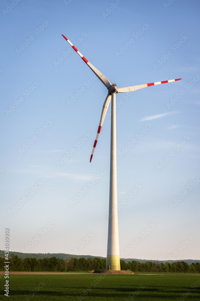 Wind turbines for green engergy at sunset with sky Wind turbines for green engergy at sunset with sky