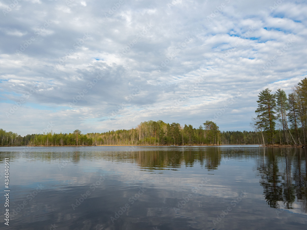Typical view of the lake in calm weather with forest on the banks in Republic of Karelia, northwest of Russia