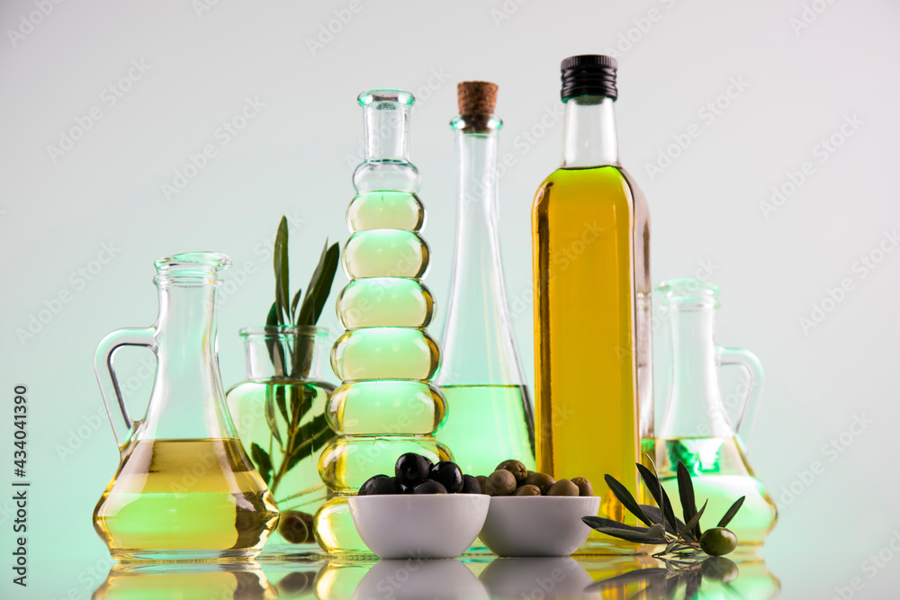 Bottles of olive oil, olive branch and Cooking oils Bottles of olive oil, olive branch and Cooking oils