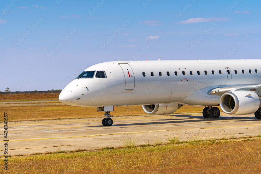 Big passenger airplane drives along the runway in airport Big passenger airplane drives along the runway in airport