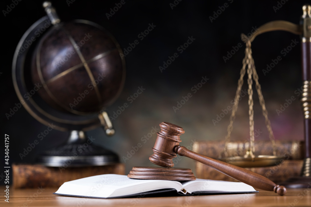 Law and justice concept, wooden gavel, globe background Law and justice concept, wooden gavel, globe background