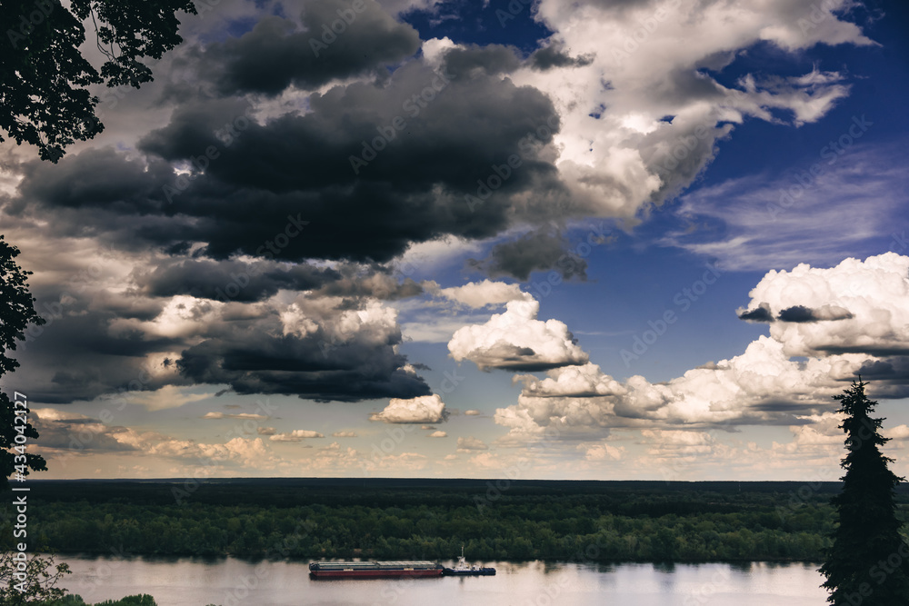 barge on the river under the sky with clouds