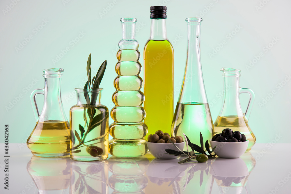 Bottles with organic cooking olive oil and olive branch Bottles with organic cooking olive oil and olive branch
