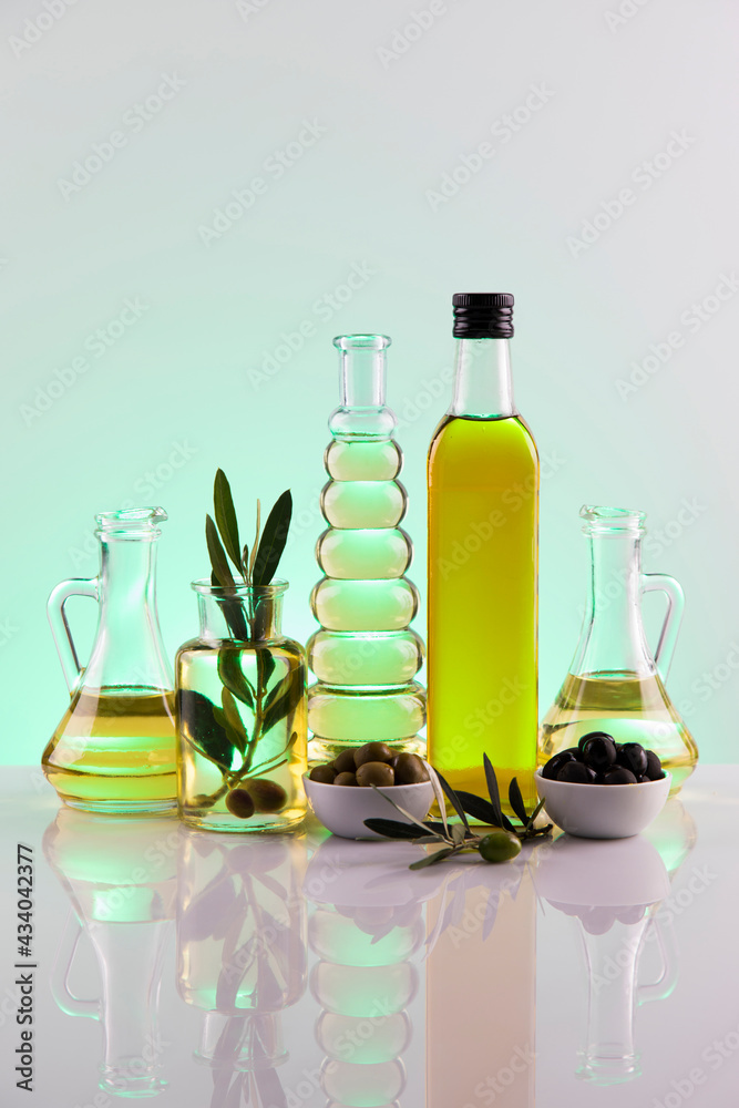 Bottles with organic cooking olive oil and olive branch Bottles with organic cooking olive oil and olive branch