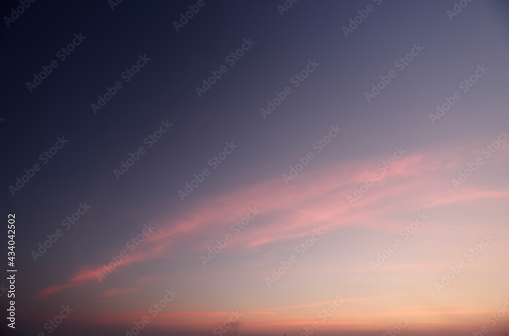 A lonely sunset dusk against a long cloud backdrop.