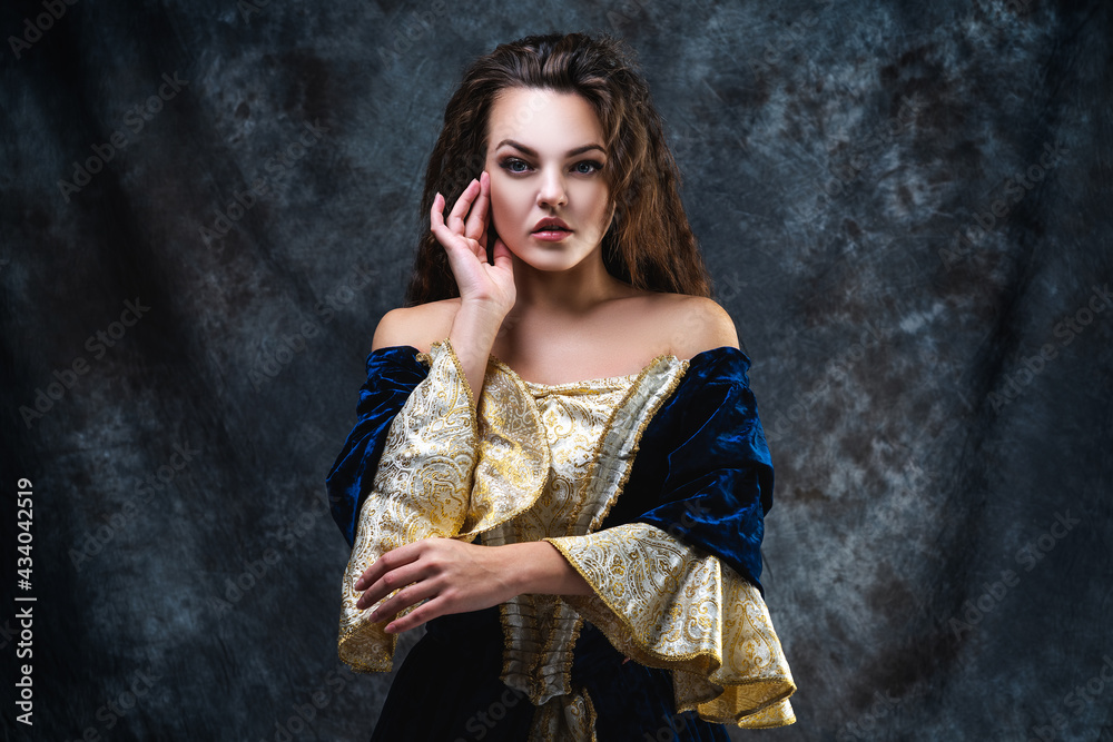Beautiful woman in renaissance dress on abstract dark background