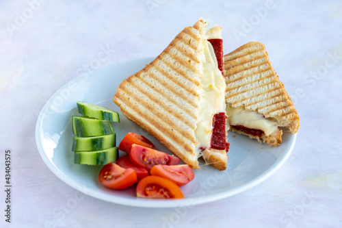 sausage and cheese toast, tomato and cucumber. photo