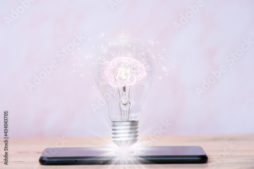 Light bulb on smartphone, idea innovation and inspiration concept, New technology in the future, ideas and thnking concept photo