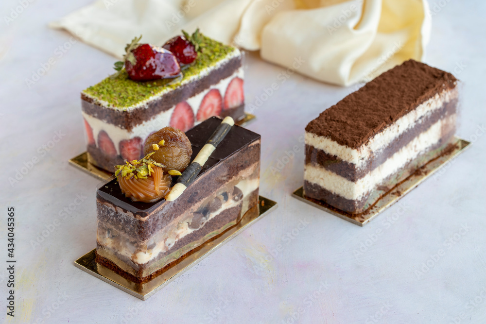 Different cakes on a white wooden background Different cakes on a white wooden background