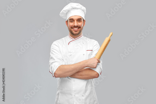 Leinwand Poster cooking, culinary and people concept - happy smiling male chef or baker in toque