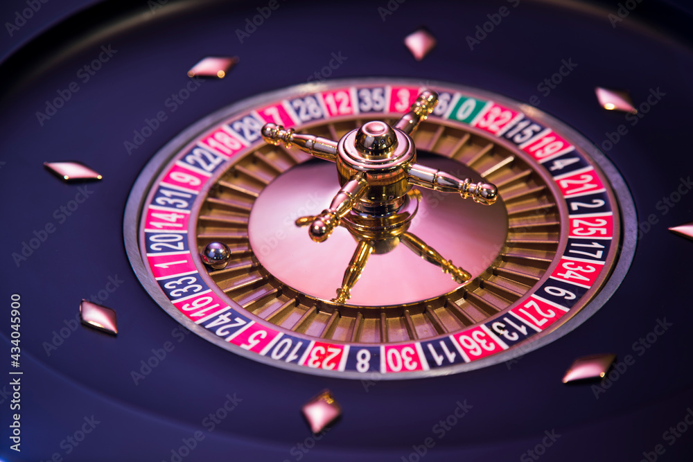 Roulette wheel in motion in a casino background Roulette wheel in motion in a casino background