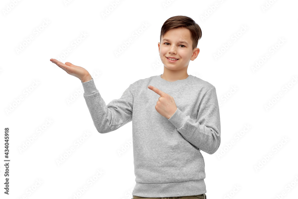 childhood, fashion and people concept - happy smiling boy holding something imaginary on his hand over white background childhood, fashion and people concept - happy smiling boy holding something imaginary on his hand over white background