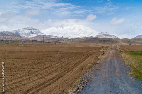 Panoramic view of a field in a rural part of central Turkey with Mount Erciyes in the background