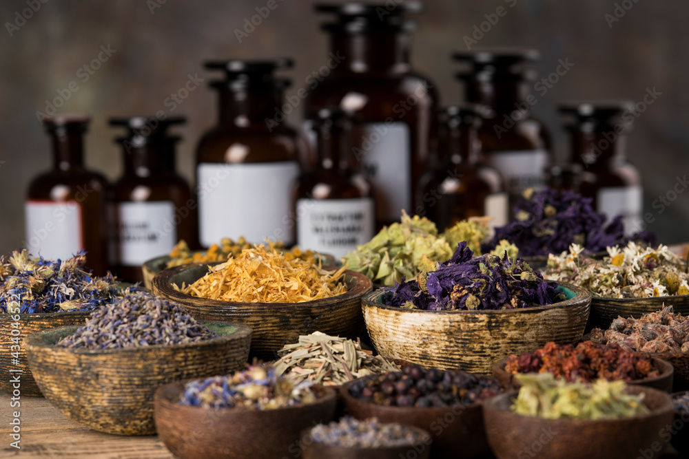 Natural medicine and mortar, healing herbs background