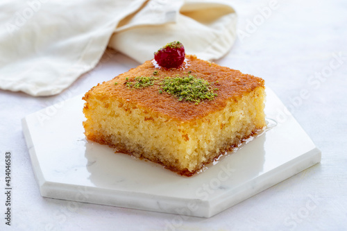Revani dessert on a white background. Traditional Ramadan flavors. Revani tatlısı photo