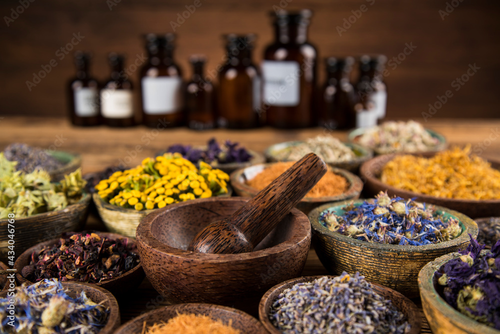Natural medicine and mortar, healing herbs background Natural medicine and mortar, healing herbs background