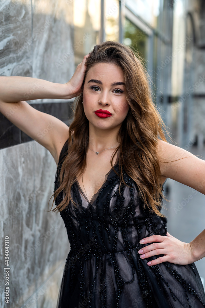 Portrait of pretty lady in evening black dress in outdoor