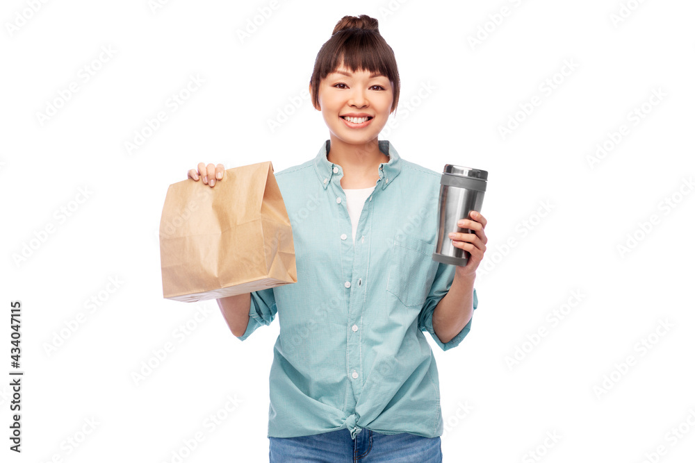 sustainability and people concept - portrait of happy smiling young asian woman in turquoise shirt with thermo cup or tumbler for hot drinks over white background sustainability and people concept - portrait of happy smiling young asian woman in turquoise shirt with thermo cup or tumbler for hot drinks over white background