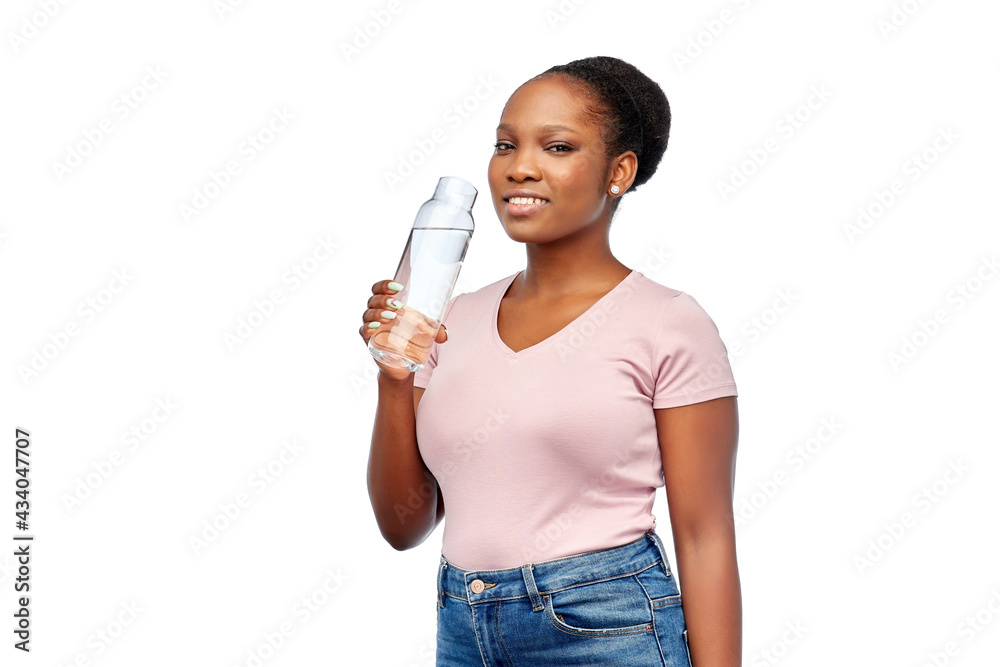 people concept - portrait of happy smiling young african american woman drinking water from reusable glass bottle over white background people concept - portrait of happy smiling young african american woman drinking water from reusable glass bottle over white background