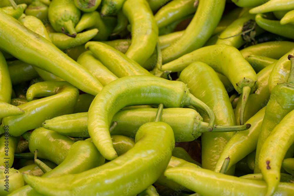 Fresh green peppers in the market. pepper in bulk. ripe peppers in a street market. yellow wax pepper Fresh green peppers in the market. pepper in bulk. ripe peppers in a street market. yellow wax pepper