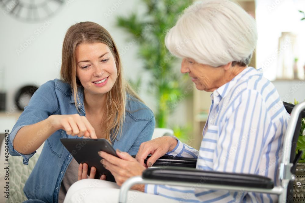 health visitor and a senior woman with tablet health visitor and a senior woman with tablet
