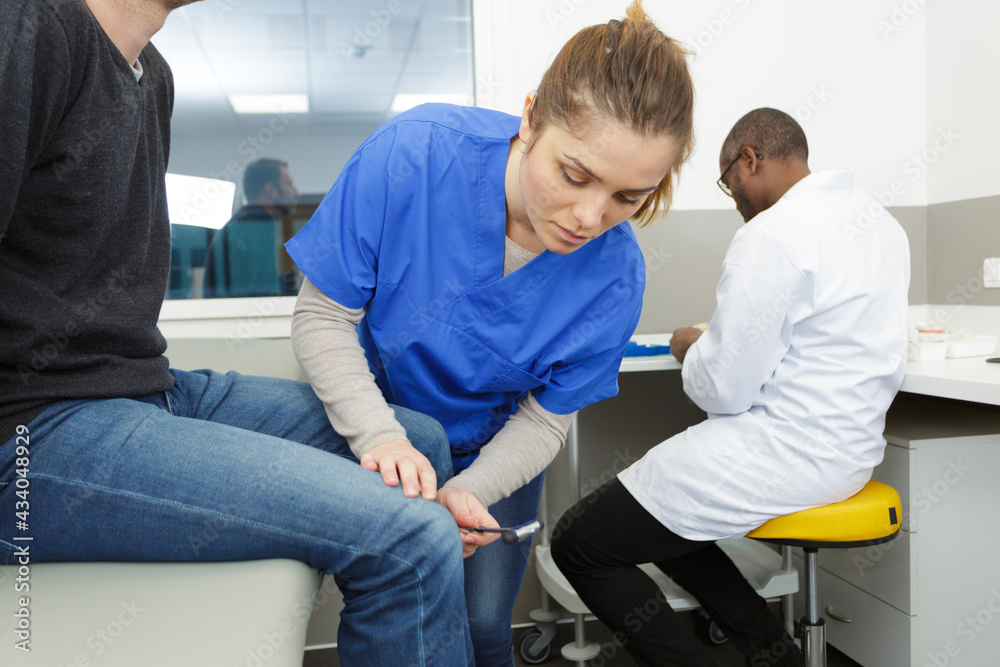 nurse using examining patient knee jerk reflex nurse using examining patient knee jerk reflex