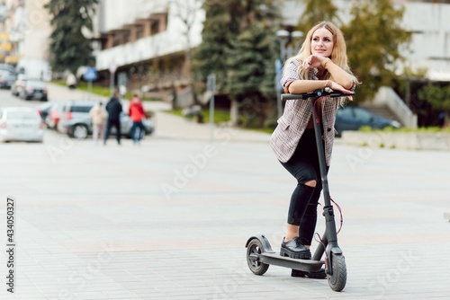 Girl in electric scooter riding in the old city center