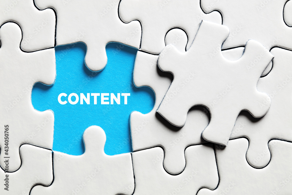 Fototapeta premium The word content on a missing puzzle piece. Online website content