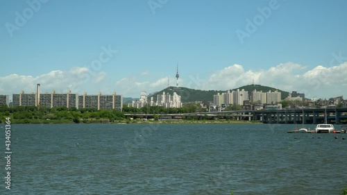 Han river near Banpo bridge, Namsan N Seoul tower on Background, Catamaran and sail boat floating in dock, wide angle, static photo