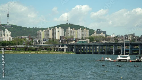 Han river near Banpo bridge, Catamaran and sailing boat floating in dock Namsan Seoul Tower on Background on cloudy sunny day no dust, wide-angle, static photo