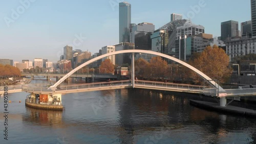 Aerial tracking the Evan Walker Bridge on the Yarra River, Melbourne, Southbank, Australia photo