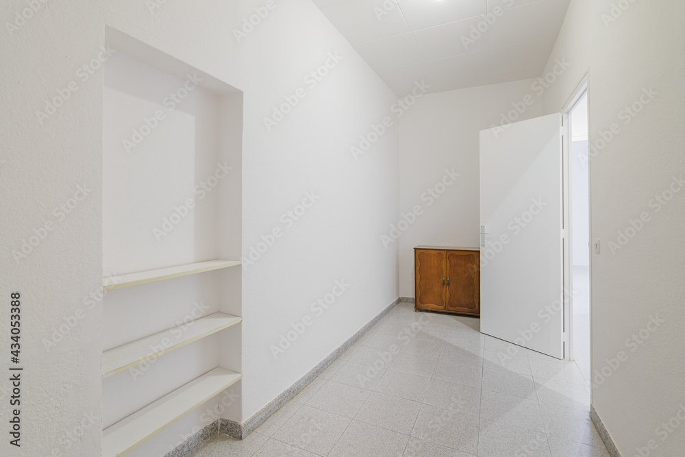 Empty small room with white walls and built-in niche for shelves in an old flat before renovation Empty small room with white walls and built-in niche for shelves in an old flat before renovation