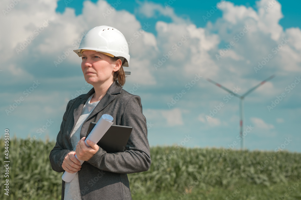 Portrait of female engineer on modern wind turbine farm Portrait of female engineer on modern wind turbine farm