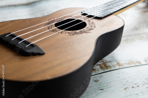  Wooden ukulele on a light background close up