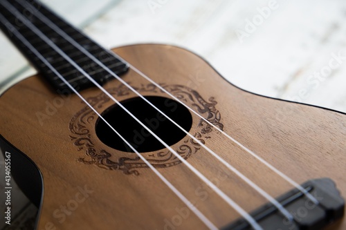 
Wooden ukulele on a light background close up