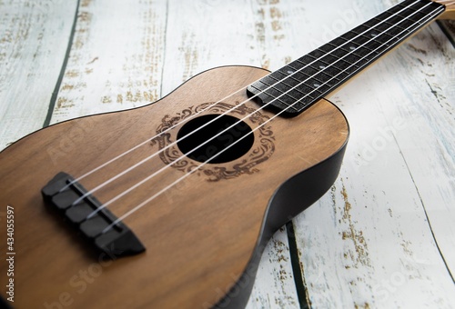  Wooden ukulele on a light background close up