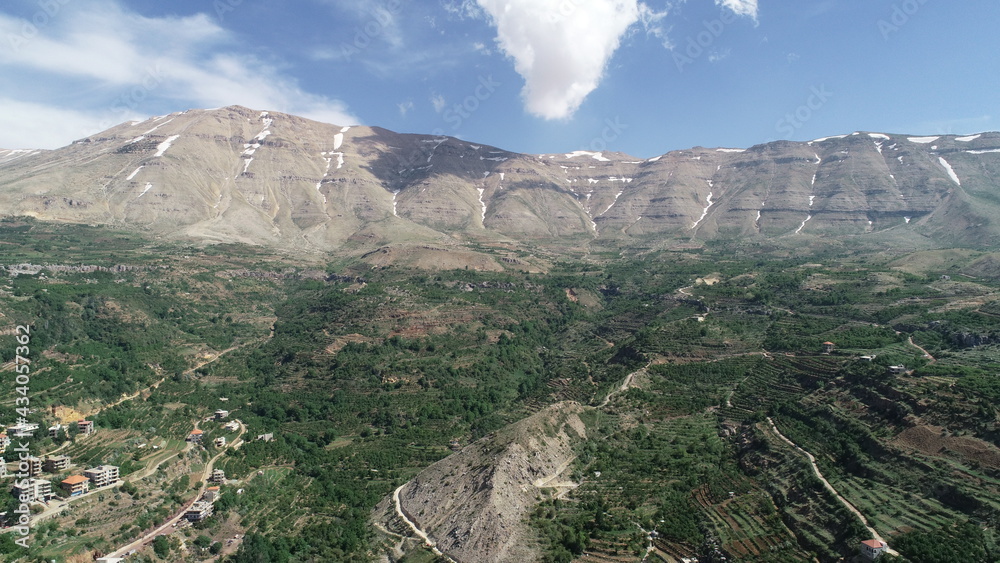 Beautiful mountain near the valley. Aerial image of the city and valley. Best hiking trails. Middle East country. Summer vacation in Lebanon. Travel trip. Mountains from bird's eye view