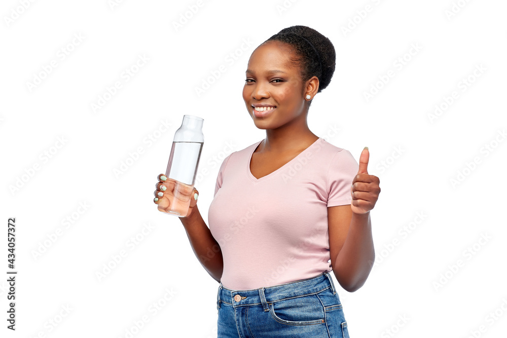 people concept - portrait of happy smiling young african american woman drinking water from reusable glass bottle over white background people concept - portrait of happy smiling young african american woman drinking water from reusable glass bottle over white background