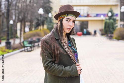 Portrait of a beautiful and stylish hippie girl in a hat on the street © Павел Костенко