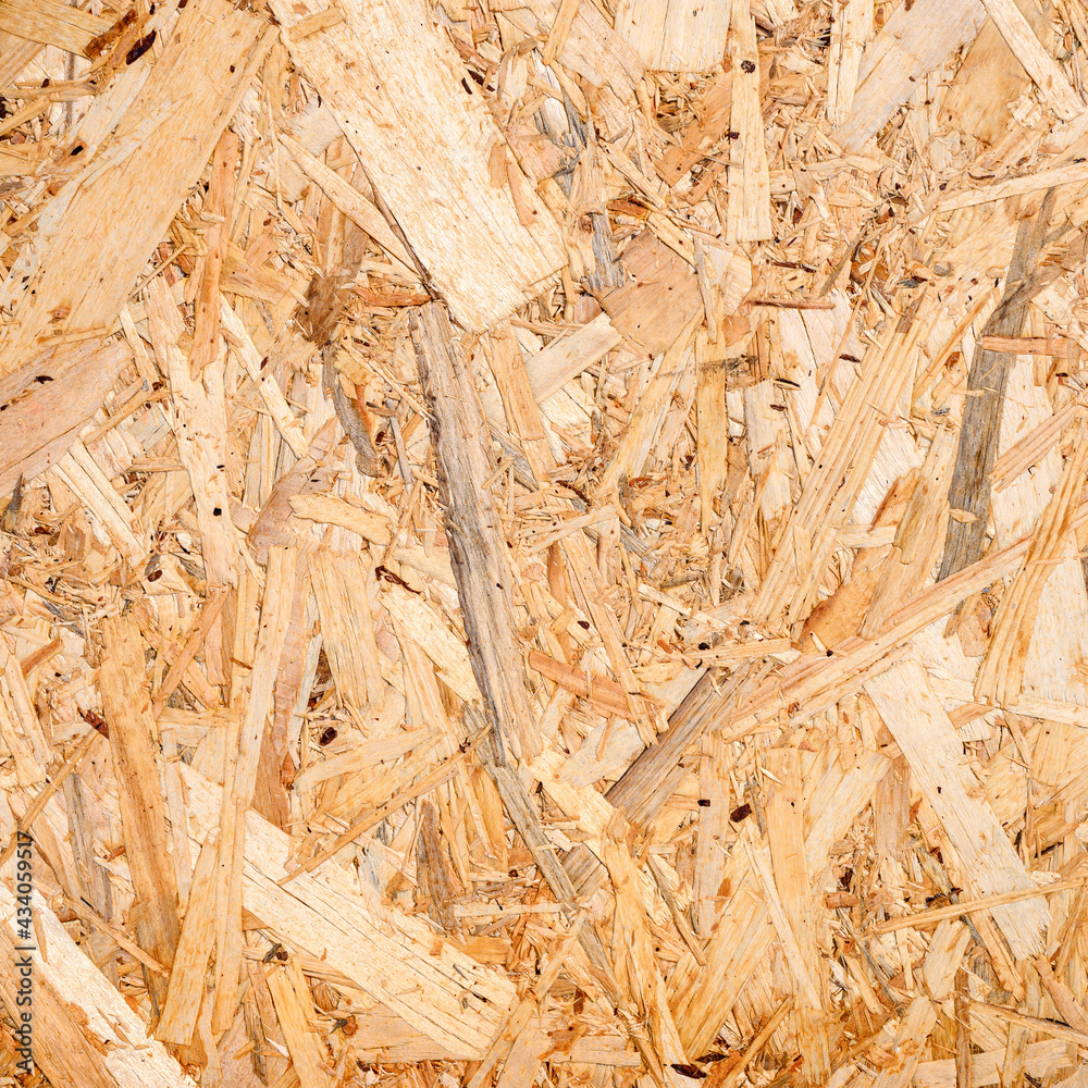 abstract textured background of compressed plywood. texture of light brown pressed wooden board chipboard. top view, close up. square abstract textured background of compressed plywood. texture of light brown pressed wooden board chipboard. top view, close up. square
