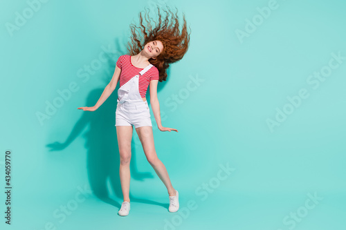 Fototapeta Naklejka Na Ścianę i Meble -  Full length body size view of nice-looking cheerful girl throwing hair having fun isolated bright blue color background