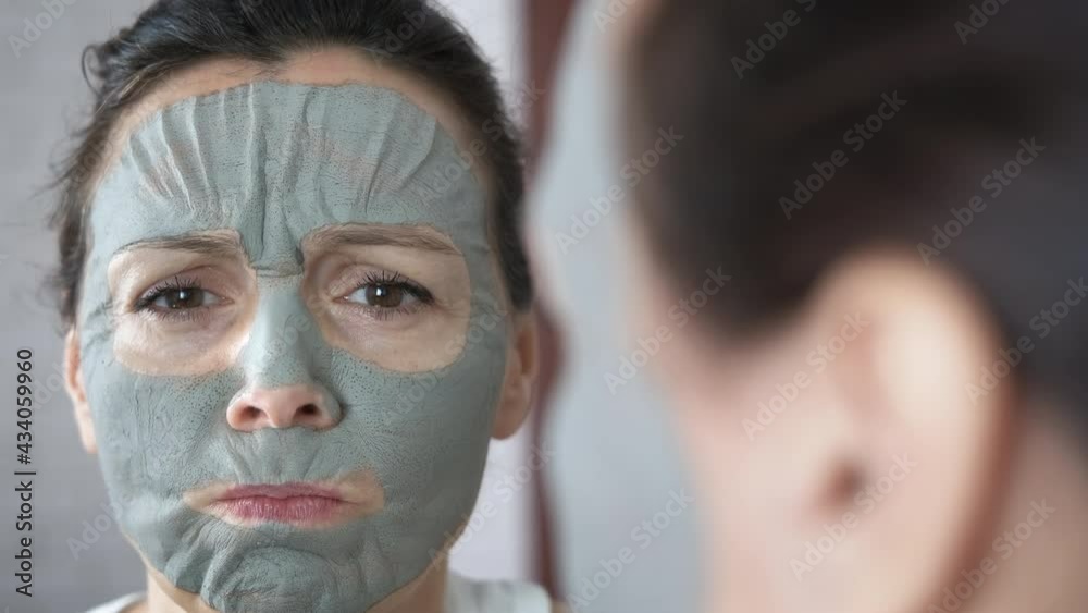 Clay face mask. Funny woman with a clay mask on her face. Clay face mask. Funny woman with a clay mask on her face.